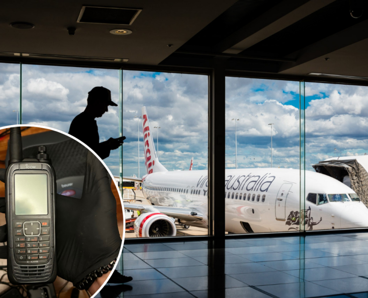 a man using a cell phone in an airport