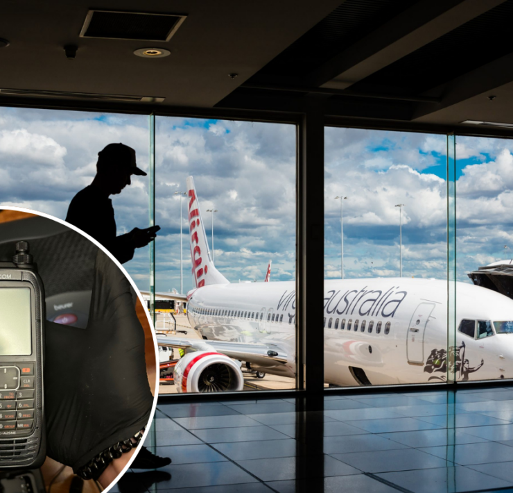 a man using a cell phone in an airport