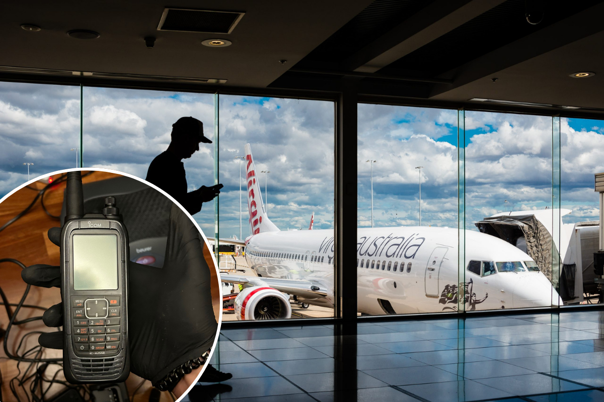 a man using a cell phone in an airport