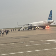 a group of people standing around an airplane