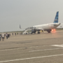 a group of people standing around an airplane