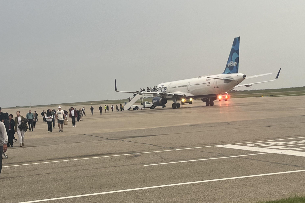 a group of people standing around an airplane