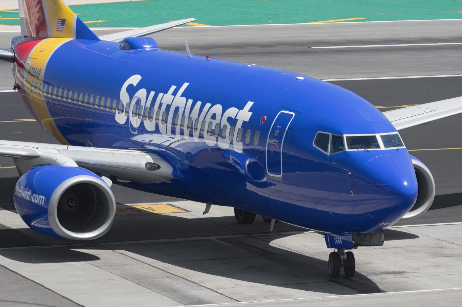 a blue airplane on a runway