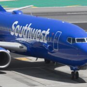 a blue airplane on a runway