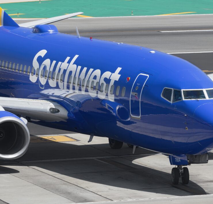 a blue airplane on a runway