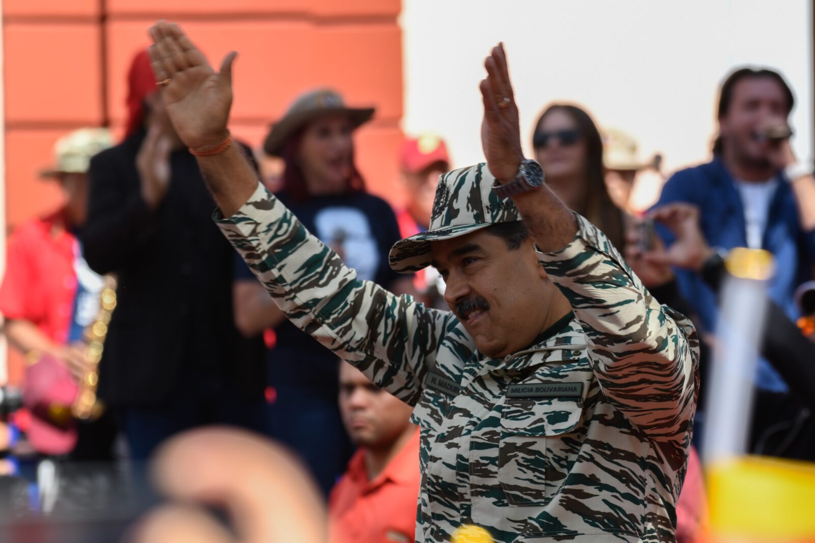 a man in a military uniform with his hands up