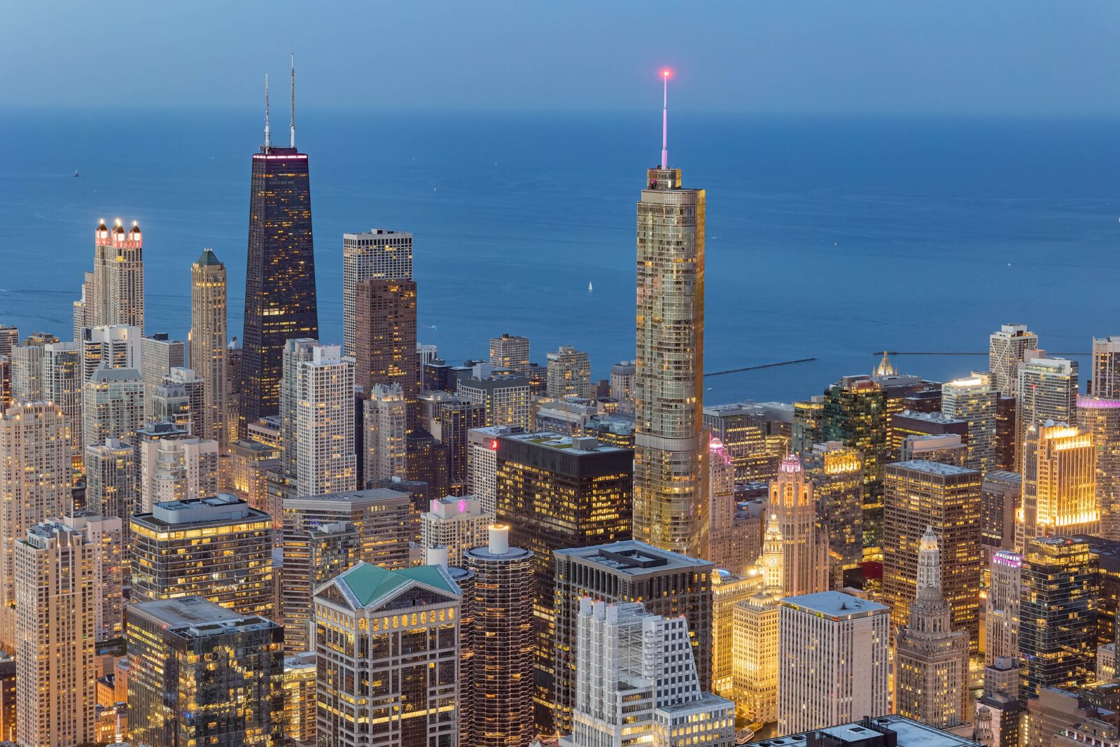 a city skyline with many tall buildings and a body of water