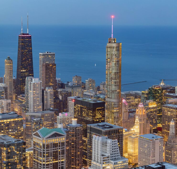 a city skyline with many tall buildings and a body of water