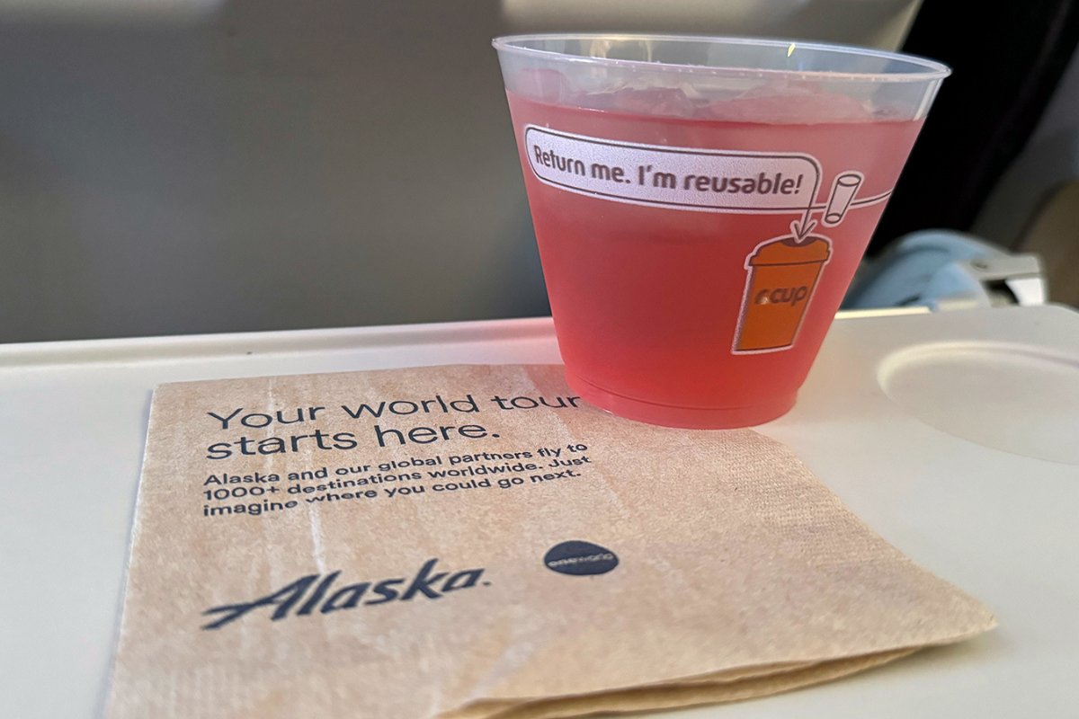 a cup of pink liquid on a napkin