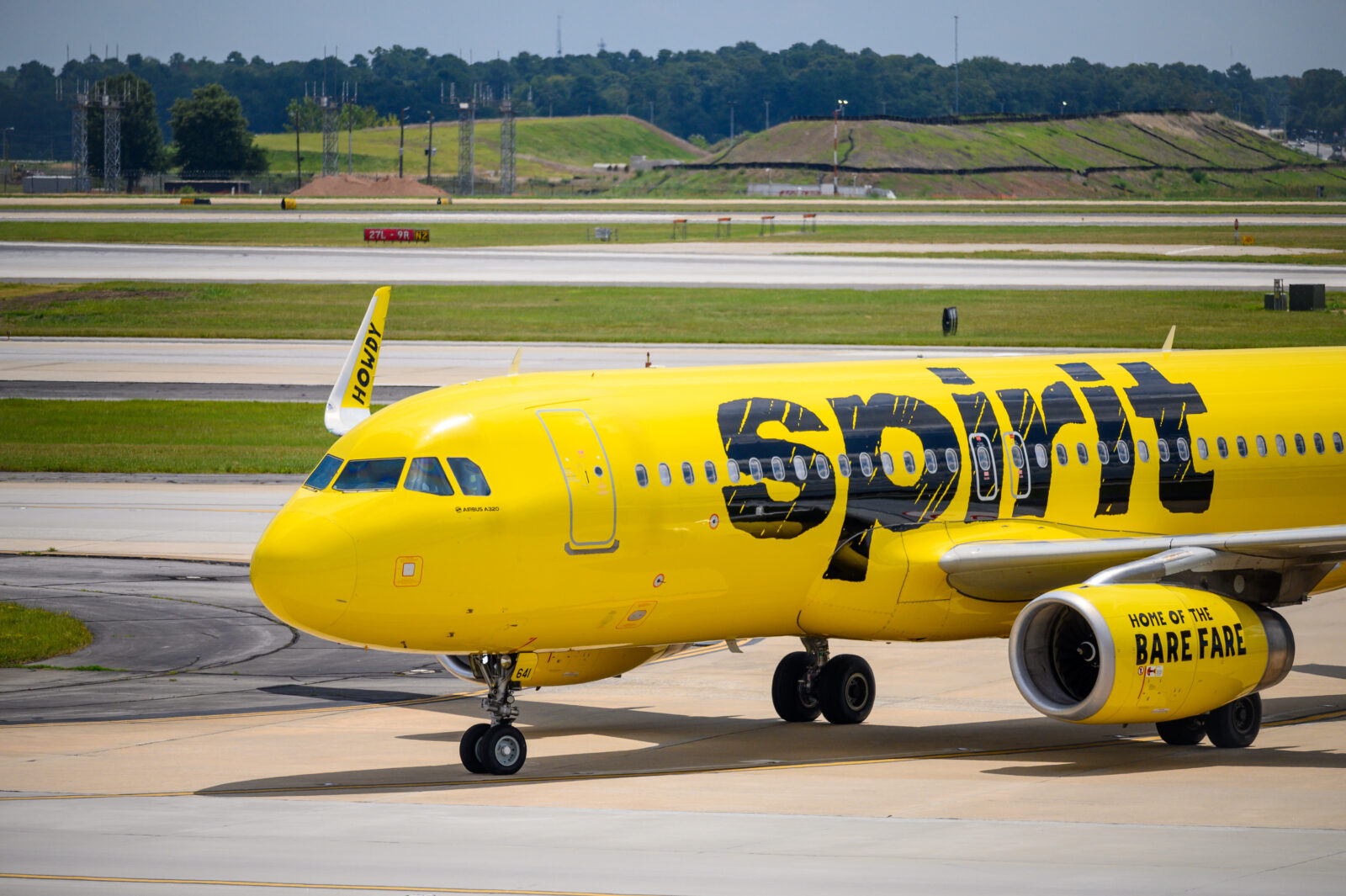 a yellow airplane on a runway