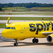 a yellow airplane on a runway