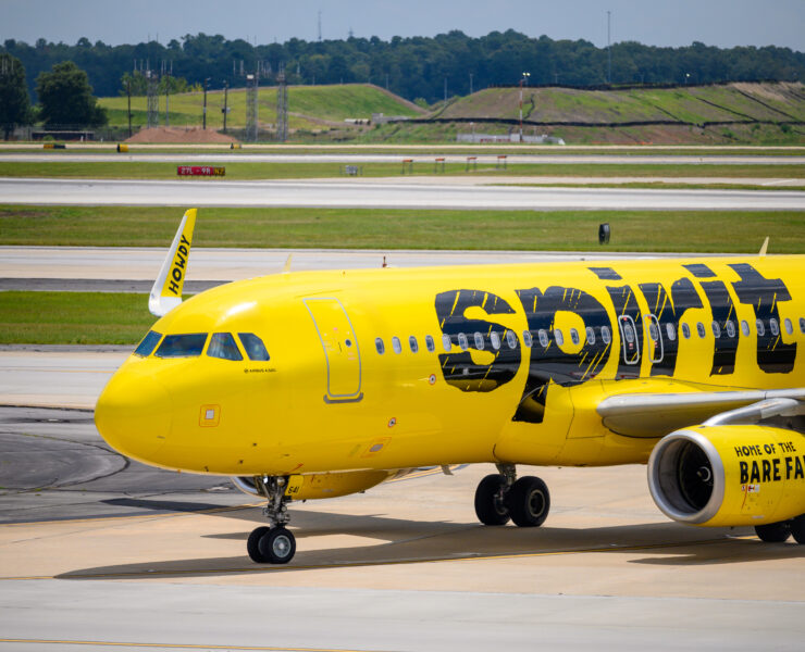 a yellow airplane on a runway