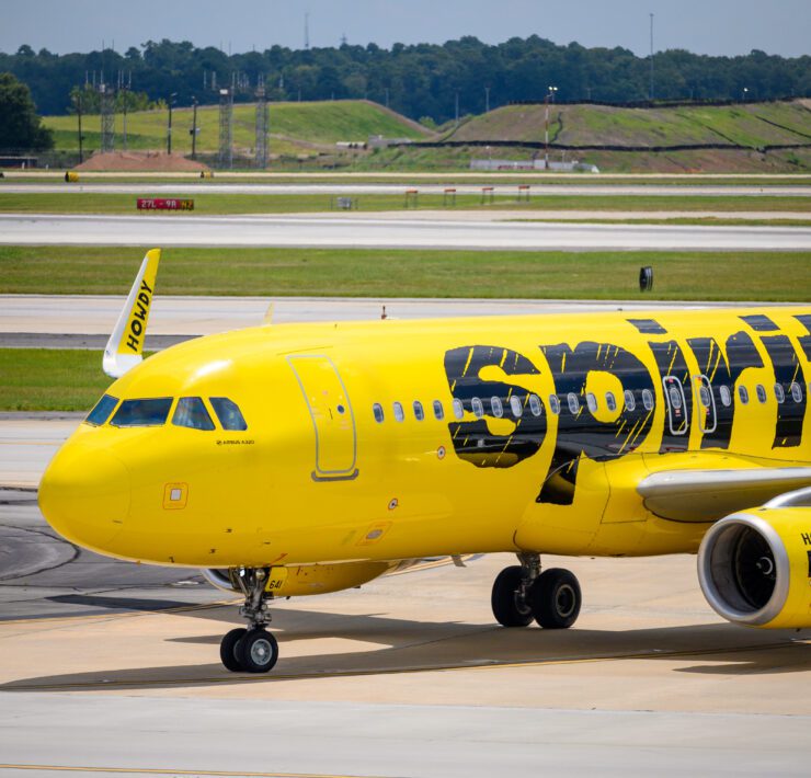 a yellow airplane on a runway