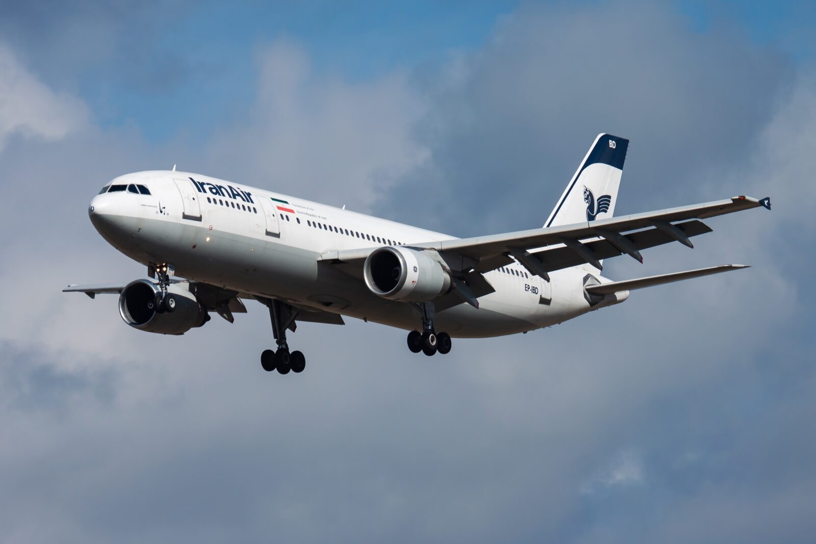 a white airplane flying in the sky