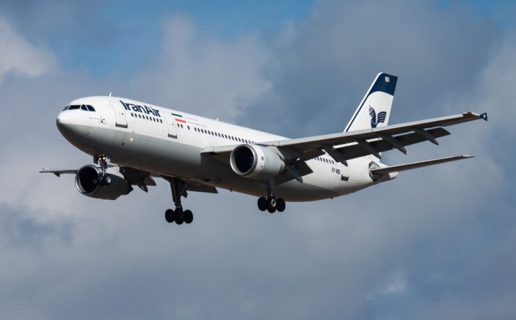 a white airplane flying in the sky