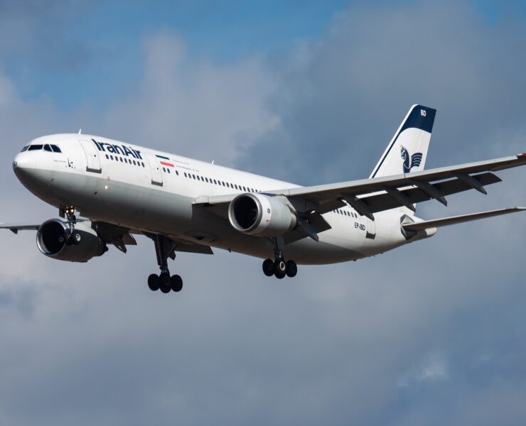 a white airplane flying in the sky