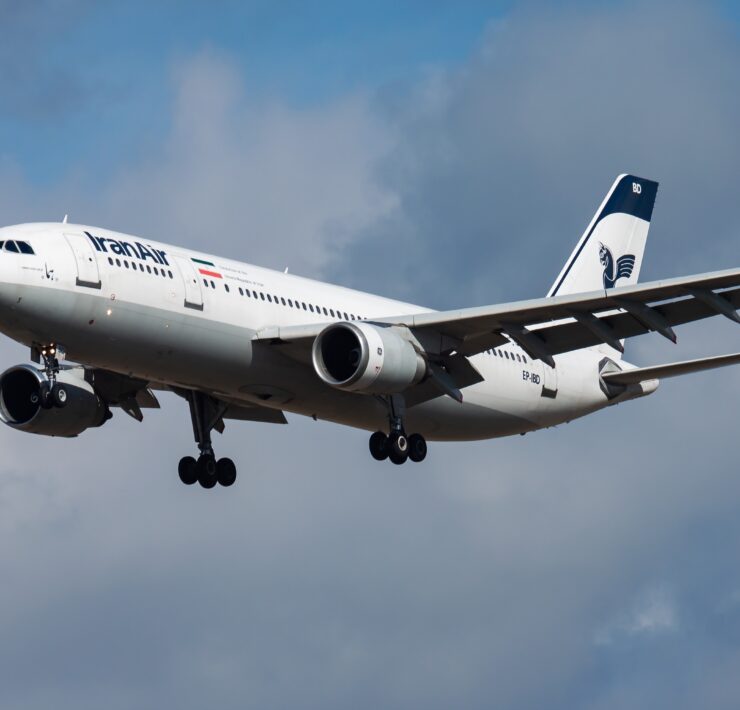 a white airplane flying in the sky