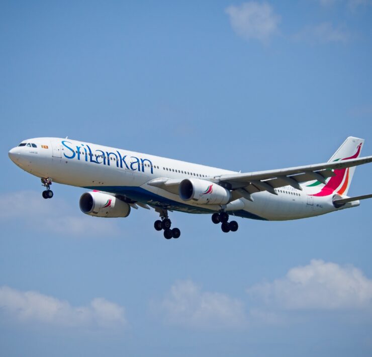 a white airplane flying in the sky