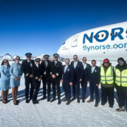 a group of people standing in front of a plane