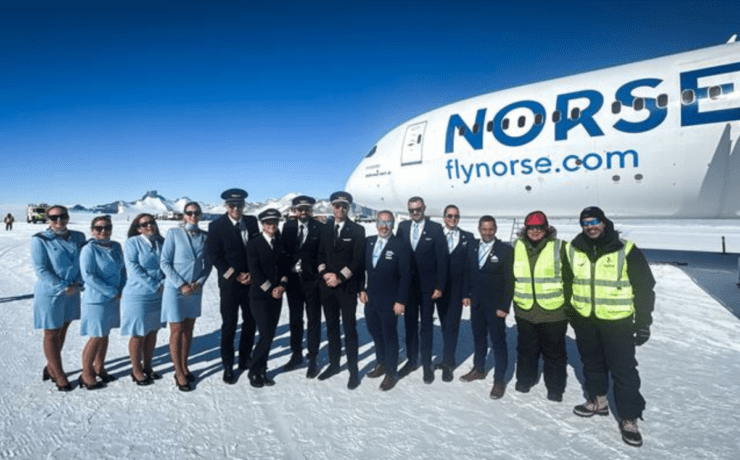 a group of people standing in front of a plane