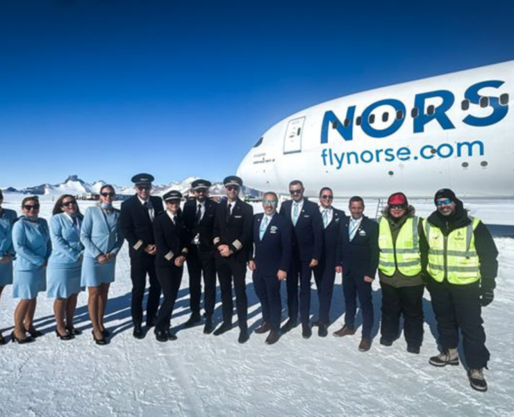 a group of people standing in front of a plane