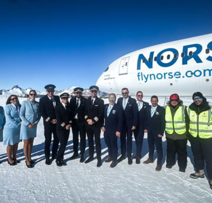 a group of people standing in front of a plane