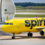 a yellow airplane on a runway