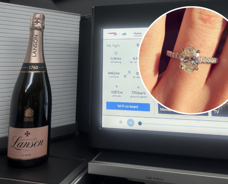 a champagne bottle and a ring on a finger