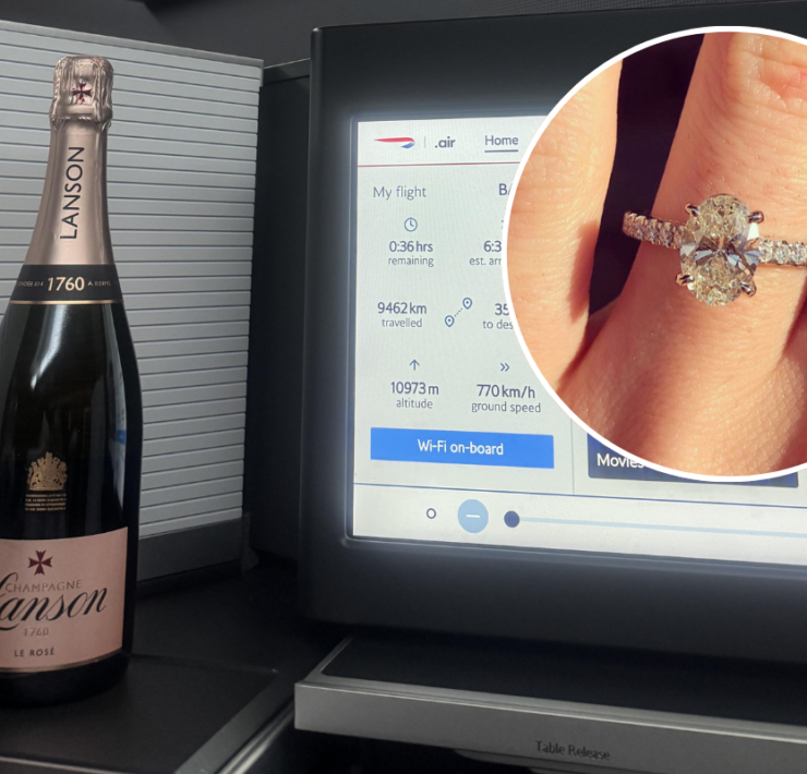 a champagne bottle and a ring on a finger