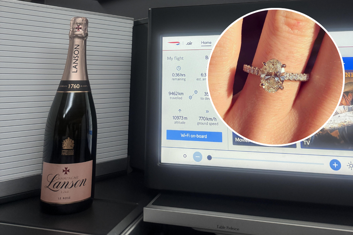 a champagne bottle and a ring on a finger