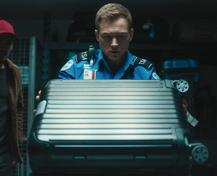 a man in uniform holding a suitcase