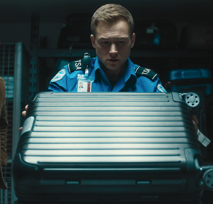 a man in uniform holding a suitcase