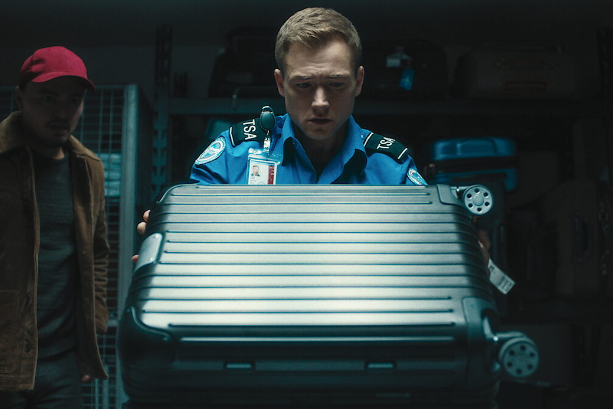 a man in uniform holding a suitcase