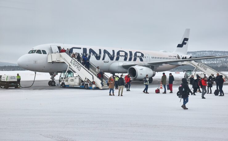 a group of people boarding an airplane