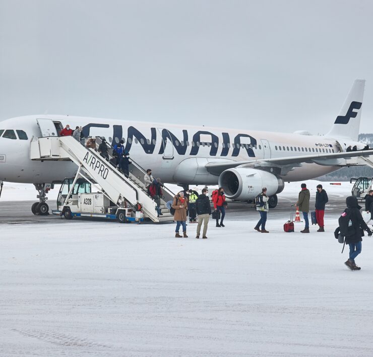 a group of people boarding an airplane