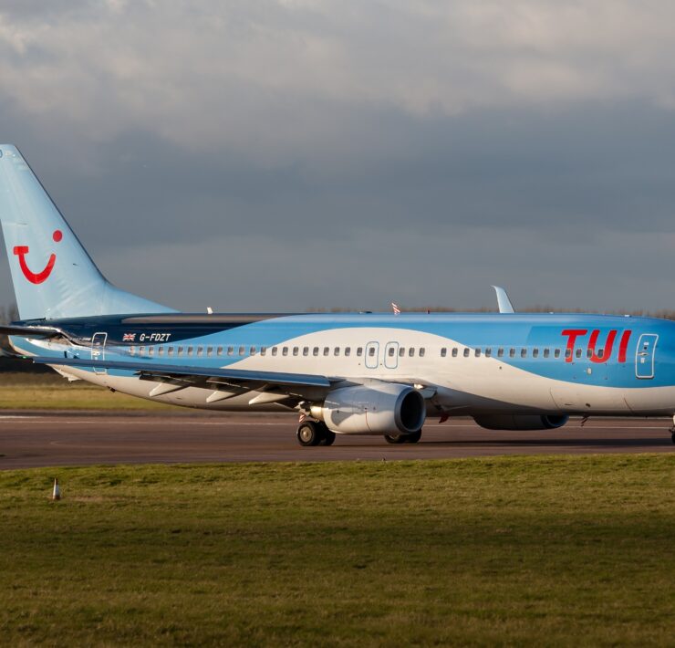 a blue and white airplane on a runway