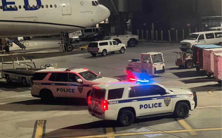 police cars parked on a tarmac at night