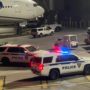 police cars parked on a tarmac at night