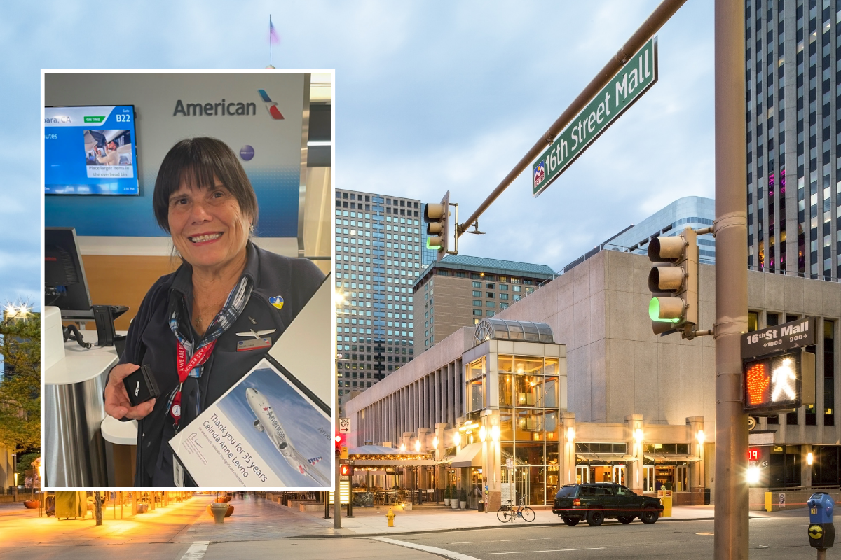 a street sign and a woman on the corner of a street