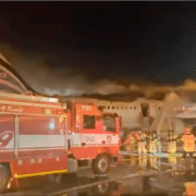 firemen standing around a fire truck