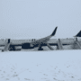 a plane parked on a snowy runway