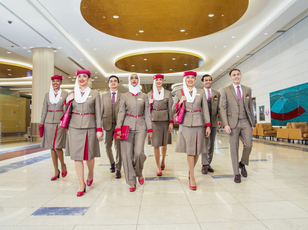 a group of people in suits walking in a hallway