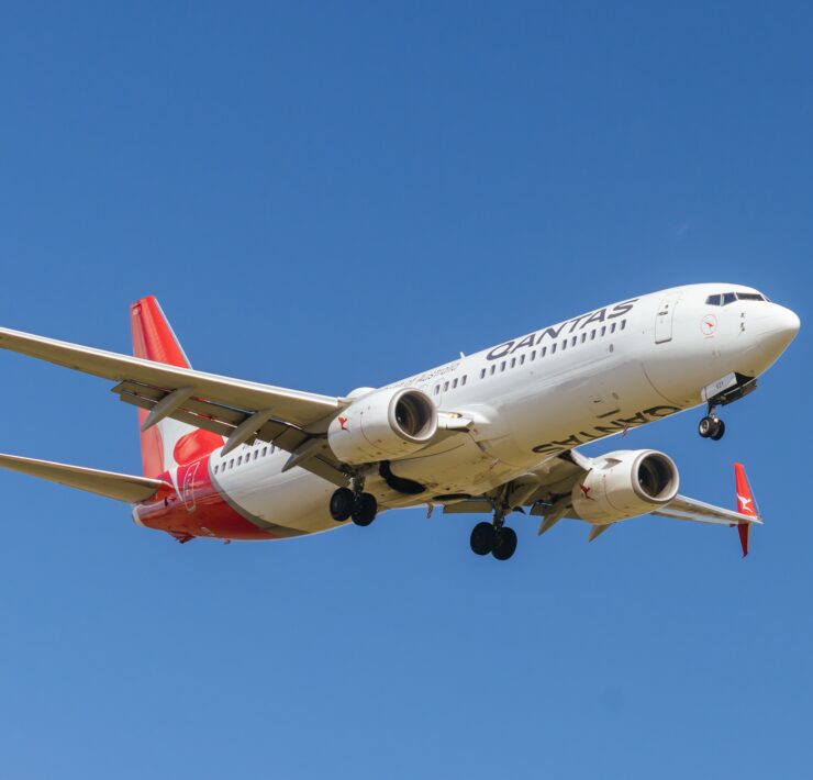 a white and red airplane in the sky