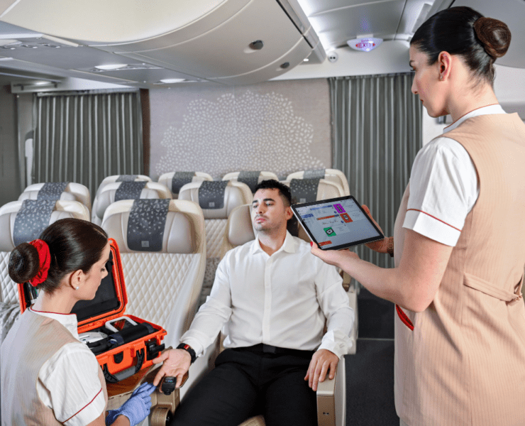 a woman holding a tablet showing a man a suitcase