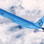 a blue airplane in the sky